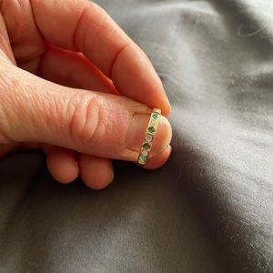 Gold ring; size 6.5 with emerald and white diamonds.